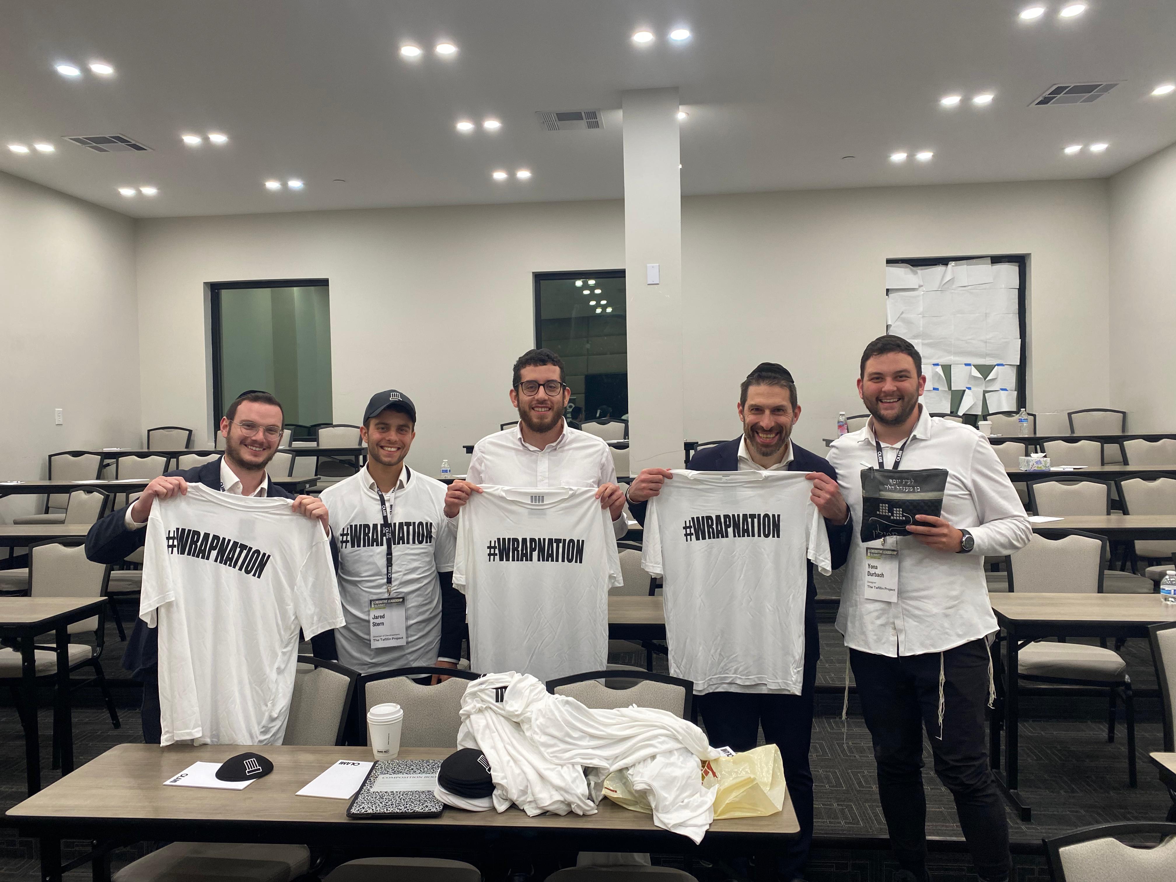 The Tefillin Project team holding up Wrap Nation shirts